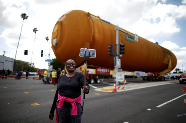 Eddye Chapman takes a picture of herself as the space shuttle Endeavour's external fuel tank ET-94 makes its way to the California Science Center in Exposition Park in Los Angeles, California, U.S. May 21, 2016. (Photo by Lucy Nicholson/Reuters)