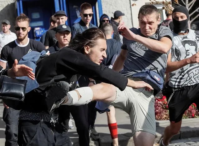 Anti-LGBT protesters attack a participant in the KharkivPride march in support of the LGBT community in Kharkiv, Ukraine September 15, 2019. (Photo by Gleb Garanich/Reuters)