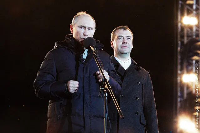 Russian Prime Minister and presidential candidate Vladimir Putin speaks as current President Dmitry Medvedev (R) listens during a rally after Putin claimed victory in the presidential election at the Manezhnya Square March, 4, 2012 in Moscow, Russia