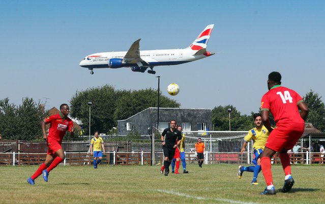 General view as a British Airways aeroplane comes in to land at Heathrow Airport during the Cherry Red Records Combined Counties Football League Division One match between Bedfont & Feltham and AFC Hayes at The Orchard on August 26, 2019 in Bedfont, England. (Photo by Catherine Ivill/Getty Images)