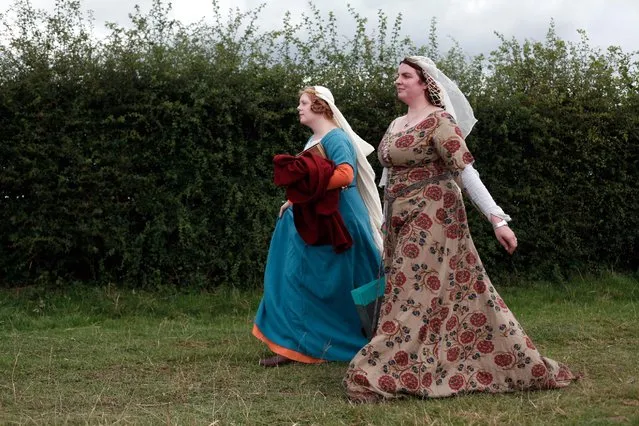 Women wear Medieval garb during the reenactment of the Battle of Agincourt, in Agincourt, northern France, Saturday, July 25, 2015. (Photo by Thibault Camus/AP Photo)