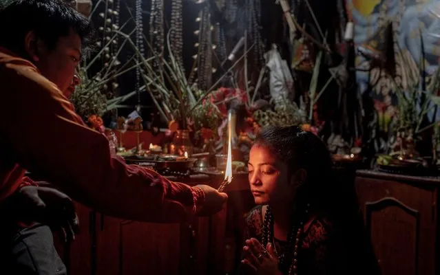 Chet Bahadur Thing (L), aged 26, a renowned shaman in the ethnic Tamang community, transforms aspiring shaman Sheela Lamichhane's evil spirit into a good spirit after the completion of a ritual in Kathmandu, Nepal, 05 September 2019. Shamans, or “Jhakri”, as they are known in Nepal, are healers who provide spiritual and physical healing and cleansing. Using a combination of Hindu worship, mantras, meditation and traditional herbal remedies, the shamans are believed to help people who have been unable to find a cure through modern medicine or who have become possessed by spirits. (Photo by Narendra Shrestha/EPA/EFE/Rex Features/Shutterstock)