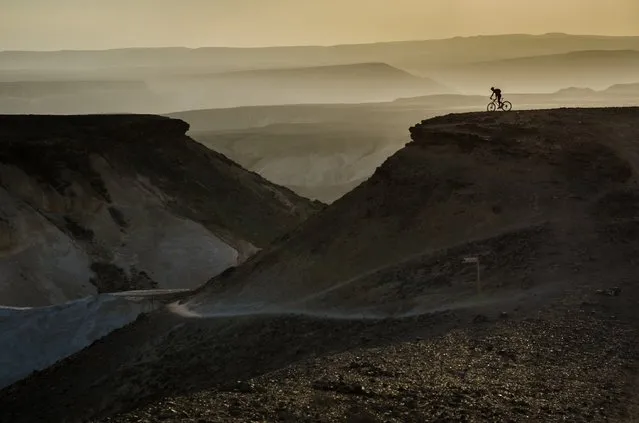 “Adventure awaits”. It was the end of a long, epic mountain bike ride through the Negev desert in Israel when we arrived at the Tzaror mountain lookout. Our guide continued to the “official” lookout on the next hill, while all of us just stopped at the first moment we saw the fantastic view. The setting sun lighting up the bit of haze between the hills on the horizon gave the perfect backdrop for our guide on the hill. Photo location: Tzaror mountain lookout, Negev desert, Israel. (Photo and caption by Ilan Shacham/National Geographic Photo Contest)