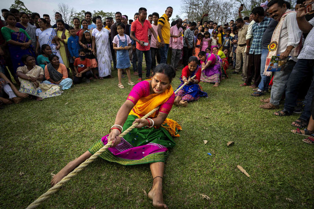 Indian women participate in a tug of war during Suwori Tribal festival in Boko, west of Gauhati, India, Wednesday, April 20, 2022. Traditional tug of war and dances mark this festival which coincides with the Assamese Rongali Bihu, or the harvest festival of the northeastern Indian state of Assam. (Photo by Anupam Nath/AP Photo)