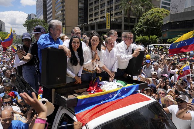 Maria Corina Machado, center, leads a protest against the reelection of President Nicolás Maduro one month after the disputed presidential vote which she claims the opposition won by a landslide, in Caracas, Venezuela, Wednesday, August 28, 2024. (Photo by Ariana Cubillos/AP Photo)