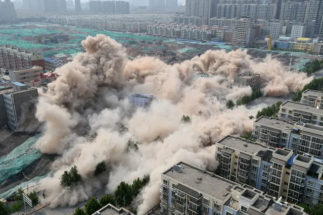 Buildings crumble during a controlled demolition for the reconstruction of urban villages in Zhengzhou, Henan province, China June 12, 2017. (Photo by Reuters/Stringer)