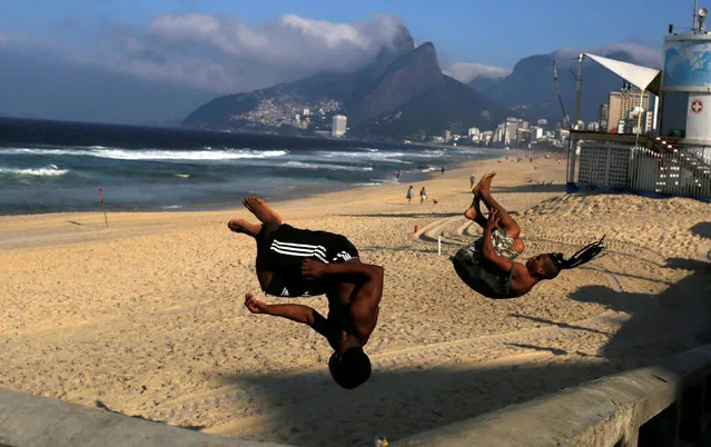 Boys practice parkour at the Ipanema beach in Rio de Janeiro, Brazil, June 18, 2016. (Photo by Pilar Olivares/Reuters)