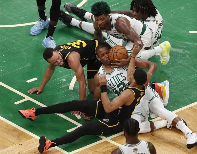 Boston Celtics center Al Horford (C) lands on Golden State Warriors guard Stephen Curry’s leg (L) while going for a loose ball with Golden State Warriors guard Jordan Poole (Bottom) and Boston Celtics guard Marcus Smart (Top) during the second half of the National Basketball Association (NBA) Finals playoff game three between the Boston Celtics and the Golden State Warriors at the TD Garden in Boston, Massachusetts, USA, 08 June 2022. (Photo by Amanda Sabga/EPA/EFE)