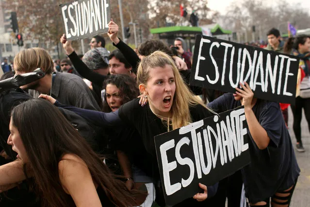 Demonstrators hold banners reading “Student” during a “March by the Education” called by the Chilean student federations requesting free and quality public education, in Santiago Chile, June 23, 2016. (Photo by Pablo Sanhueza/Reuters)