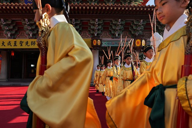 People attend the birthday of Confucius to commemorate Teachers day at a Confucius temple in Taichung, Taiwan on September 28, 2024. (Photo by Ann Wang/Reuters)