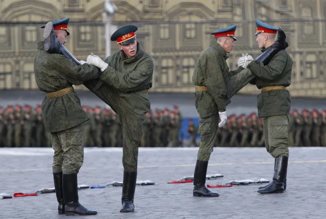 Russian servicemen stretch before a rehearsal for the annual Victory Day parade in Moscow's Red Square. (Photo by Maxim Shemetov/Reuters)