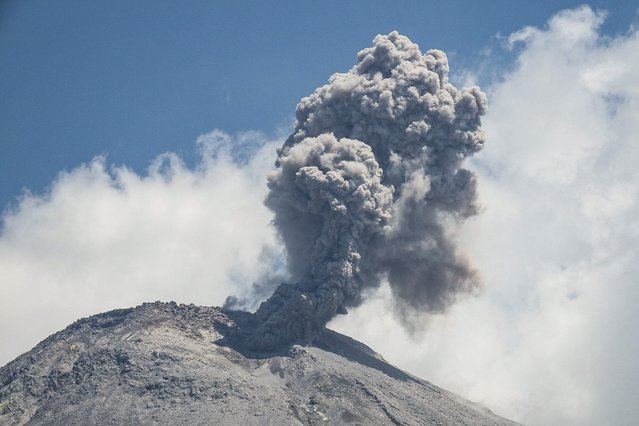 Mount Lewotobi spews volcanic ash from its crater during an eruption as seen from Duripali village in East Flores, Indonesia, on October 16, 2024. (Photo by Arnold Welianto/AFP Photo)