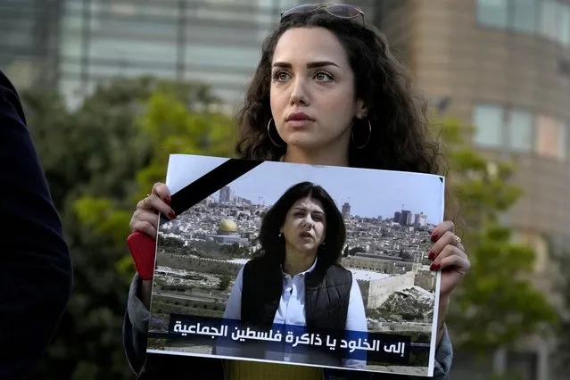 A Lebanese journalist holds a portrait of Al Jazeera journalist Shireen Abu Akleh during a protest in front of United Nations headquarters in Beirut, Lebanon, Wednesday, May 11, 2022. Abu Akleh was shot and killed on Wednesday while covering an Israeli military raid in the occupied West Bank. The broadcaster and two reporters who were with her blamed Israeli forces.  (Photo by Bilal Hussein/AP Photo)