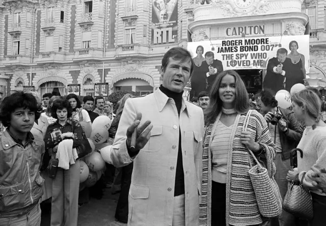 In this May 20, 1977 file photo, Roger Moore, alias British secret agent James Bond, is accompanied by co-star Barbara Bach as they arrive for the screening of “The Spy Who Loved Me” at the Cannes Film Festival on the French Riviera. (Photo by AP Photo)