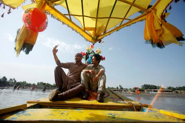 Men take a selfie while riding on a river boat on the Sardaryab river in Charsadda, Pakistan July 5, 2017. (Photo by Fayaz Aziz/Reuters)