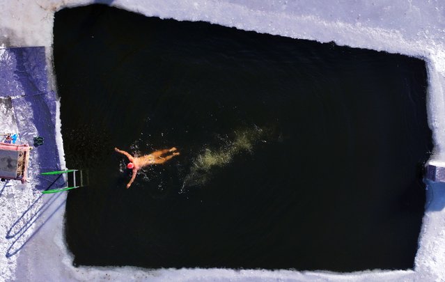 A winter swimmer swims in a pool carved out of a frozen lake along the Songhua River on December 2, 2024 in Harbin, Heilongjiang Province of China. (Photo by VCG/VCG via Getty Images)