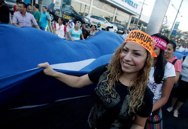 A demonstrator wears a headband that reads, “No more corruption”, during a march to demand the resignation of Honduras' President Juan Orlando Hernandez in Tegucigalpa, August 28, 2015. Protesters have been continuing demonstrations in Tegucigalpa, calling for the resignation of Hernandez over a $200 million corruption scandal at the Honduran Institute of Social Security. (Photo by Jorge Cabrera/Reuters)