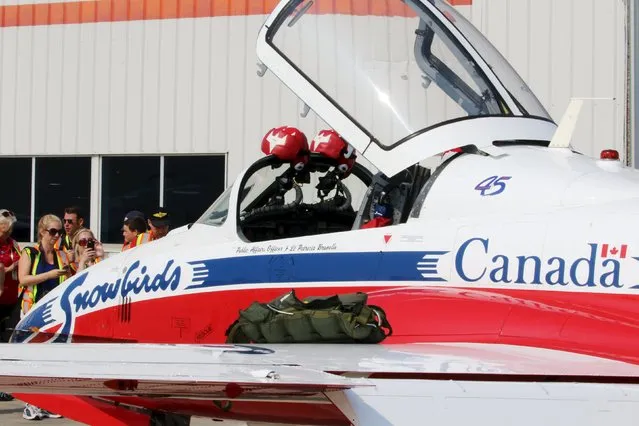 Members of the media look over a Snowbird jet during media day for the Canadian International Air Show at Pearson Airport in Toronto, Ontario, September 3, 2015. (Photo by Louis Nastro/Reuters)