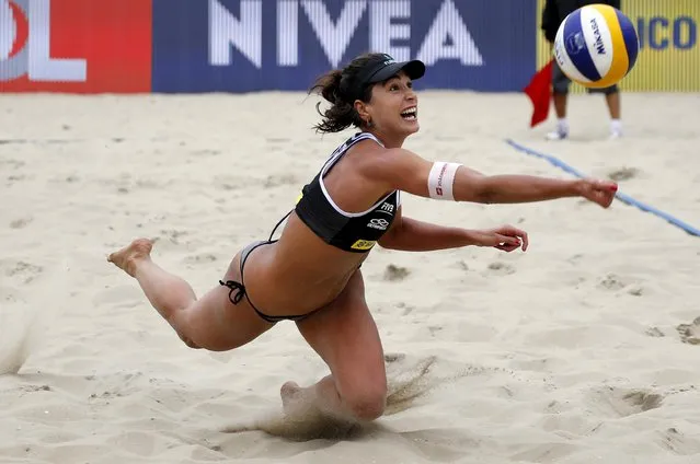 Carolina Salgado of Brazil saves a ball against Kerri Walsh and April Ross of the U.S. during their Rio Open women's beach volleyball match on Copacabana beach in Rio de Janeiro, Brazil, September 4, 2015. The Rio Open is a test event for the Rio 2016 Olympic Games. (Photo by Sergio Moraes/Reuters)