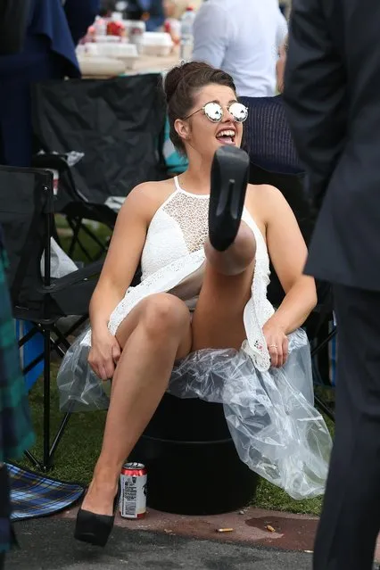 A racegoer decides to sit back and kick her heels during Caulfield Cup Day at Caulfield Racecourse on October 21, 2017 in Melbourne, Australia. (Photo by Splash News and Pictures)