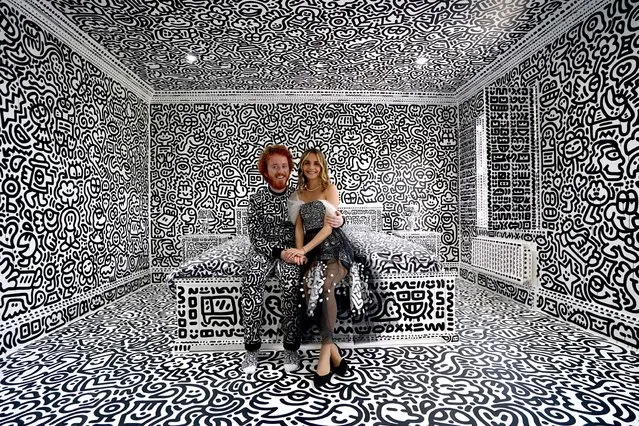 British artist Sam Cox, aka Mr Doodle, with his wife Alena, reveals on Monday, October 3, 2022 the Doodle House, a twelve-room mansion at Tenterden, in Kent, which has been covered, inside and out in the artist's trademark monochrome, cartoonish hand-drawn doodles. (Photo by Gareth Fuller/PA Images via Getty Images)