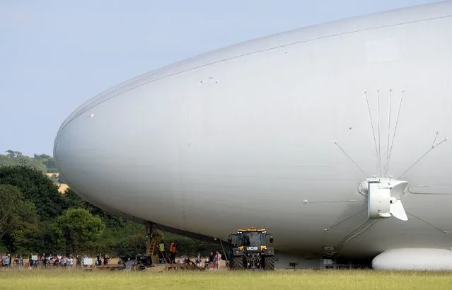 The Airlander 10, part plane, part airship, goes through pre-flight checks at Cardington airfield in Bedfordshire, England, Sunday August 14, 2016. The makers of a blimp-shaped, helium-filled airship billed as the world's biggest aircraft postponed its maiden flight at the last minute on Sunday. (Photo by Joe Giddens/PA Wire via AP Photo)