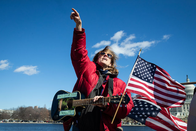 A woman sings during a protest outside the Capitol in Washington DC on February 18, 2025 against efforts by Donald Trump and Elon Musk to shrink the federal government. (Photo by Allison Bailey/NurPhoto/Rex Features/Shutterstock)