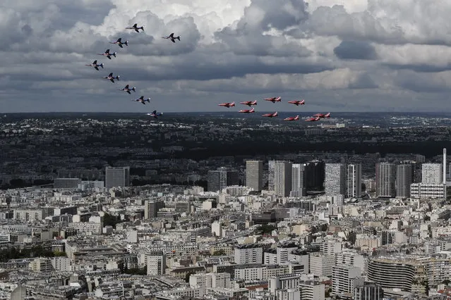 French Alpha jets of the Patrouille de France and the UK Royal red arrows aerobatic planes fly over west of Paris, Thursday, June 18, 2020 as part of commemoration for the 80th anniversary of Charles de Gaulle's radio appeal to his countrymen to resist Nazi occupation during WWII. French President Emmanuel Macron is traveling to London to mark the day that De Gaulle delivered his defiant broadcast 80 years ago urging his nation to fight on despite the fall of France. In a reflection of the importance of the event, the trip marks Macron's first international trip since France's lockdown amid the COVID-19 pandemic. (Photo by Francois Mori/AP Photo)