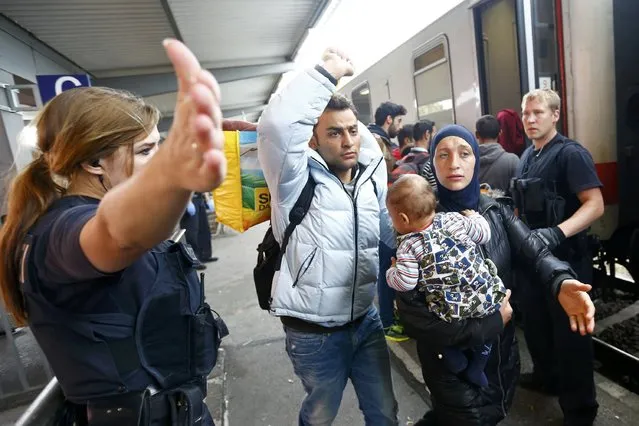 Police directs migrants at a train station near the border with Austria in Freilassing, Germany September 15, 2015. A total of 4,537 asylum seekers reached Germany by train on Monday despite the imposition of new controls at the border with Austria, the federal police said on Tuesday. The arrivals brought the number of asylum seekers who have entered Germany by train since the start of the month to 91,823, a police spokeswoman in Potsdam said. (Photo by Dominic Ebenbichler/Reuters)