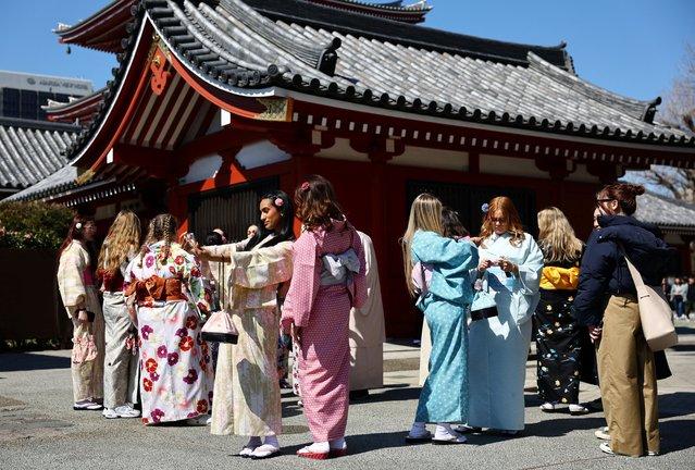 Foreign tourists wearing Japanese traditional kimono clothes stroll near Sensoji temple at Asakusa district, a popular sightseeing spot in Tokyo, Japan on March 10, 2025. (Photo by Issei Kato/Reuters)