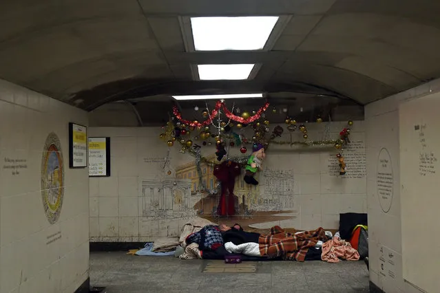 Homeless man Kel sleeps in the spot where he lives in the subway next to Hyde Park Station in London, Britain, December 19, 2017. (Photo by Mary Turner/Reuters)