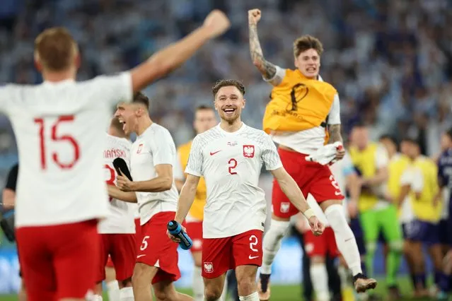 Kamil Glik (L) and Matty Cash of Poland celebrate after their side's qualification to the knockout stages during the FIFA World Cup Qatar 2022 Group C match between Poland and Argentina at Stadium 974 on November 30, 2022 in Doha, Qatar. (Photo by Adam Pretty – FIFA/FIFA via Getty Images)