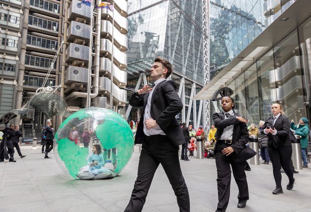 Activists from Mothers Rise Up, a campaign for climate action, dance outside Lloyd's of London, Britain, on February 26, 2024. (Photo by Anna Gordon/Reuters)