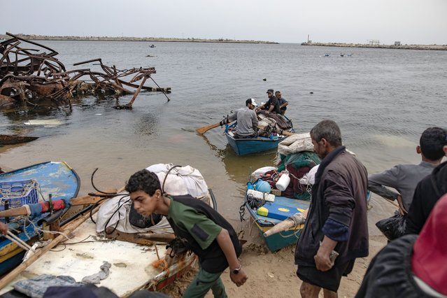 Palestinian fishermen row their boats toward the shore in Gaza, 12 May 2025. Palestinians continue fishing despite border closures and limited supply impacting availability, making fish an expensive commodity in Gaza. The United Nations estimated that daily fish catches in Gaza between October 2023 and December 2024 had plummeted to 7.3 percent of the 2022 levels, further increasing acute food insecurity and risk of famine. (Photo by Haitham Imad/EPA)