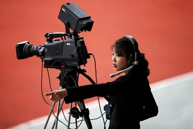 A camerawoman works during the preliminary 2018 World Cup and 2019 AFC Asian Cup qualifying soccer match between North Korea and Philippines at the Kim Il Sung Stadium in Pyongyang October 8, 2015. (Photo by Damir Sagolj/Reuters)