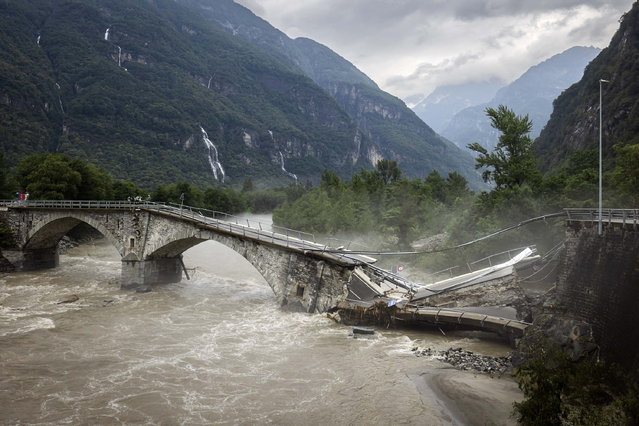 The collapsed Visletto bridge between Visletto and Cevio following storms that caused major flooding, in the Maggia Valley, Switzerland, 30 June 2024. Swiss Air-Rescue (Rega) rescuers recovered two bodies on 30 June following a landslide in the Maggia Valley. One person is still missing, according to the Ticino cantonal police. (Photo by Michael Buholzer/EPA)