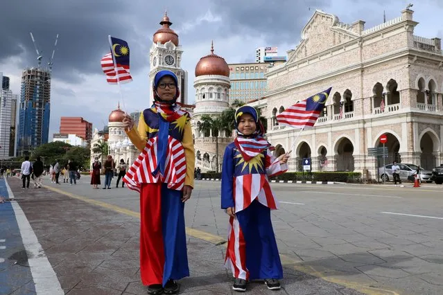 Girls wearing costumes made of Malaysian flags pose for a picture at Independence Square during Malaysia Independence Day, in Kuala Lumpur, Malaysia, August 31, 2020. (Photo by LIm Huey Teng/Reuters)