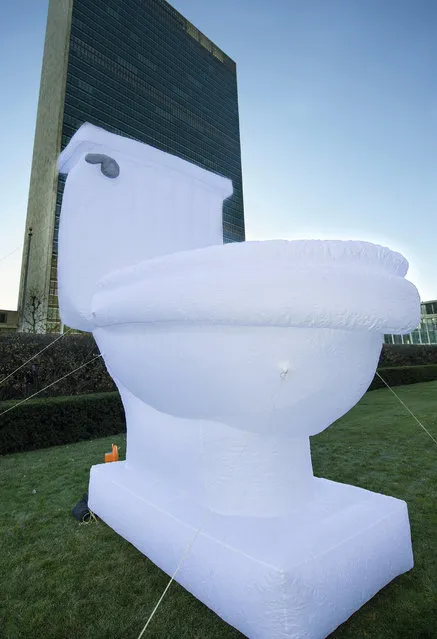 In this photo provided by the United Nations, a 15-foor-high inflatable toilet stands in front of United Nations headquarters, in observance of  “World Toilet Day”, Wednesday, November 19, 2014. (Photo by Mark Garten/AP Photo/United Nations)