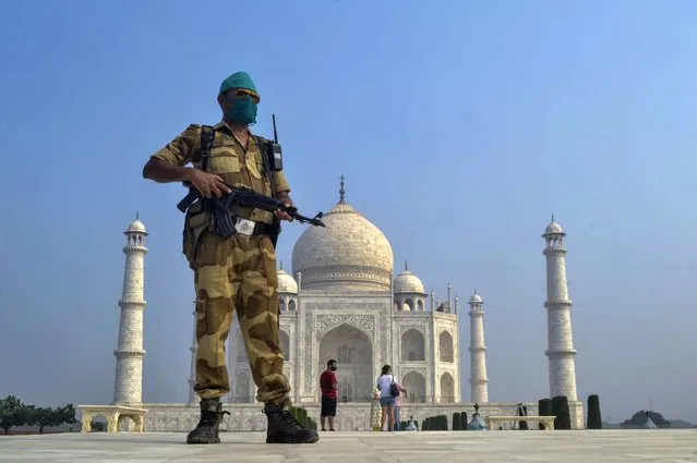 A paramilitary soldier wearing a mask stands guard as the Taj Mahal monument is reopened after being closed for more than six months due to the coronavirus pandemic in Agra, India, Monday, September 21, 2020. (Photo by Pawan Sharma/AP Photo)