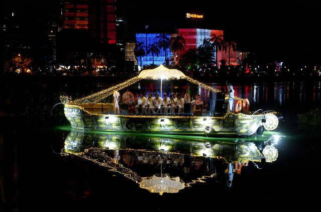 Band members of Sri Lanka Navy perform on a decorated boat in the waters of Beira Lake, on Vesak Day to commemorate the birth, enlightenment and death of Buddha, in Colombo, Sri Lanka on May 12, 2025. (Photo by Thilina Kaluthotage/Reuters)