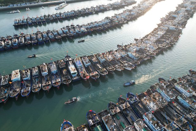 An aerial drone photo shows vessels anchored at a port to take shelter from Typhoon Podul in Xiamen, Fujian Province, southeast China 12 August 2025 (issued 13 August 2025). At 6 p.m. on 12 August, the flood control headquarters in Fujian upgraded its emergency typhoon response from Level IV to Level III in anticipation of the storm’s arrival. (Phoot by Zeng Demeng/EPA)