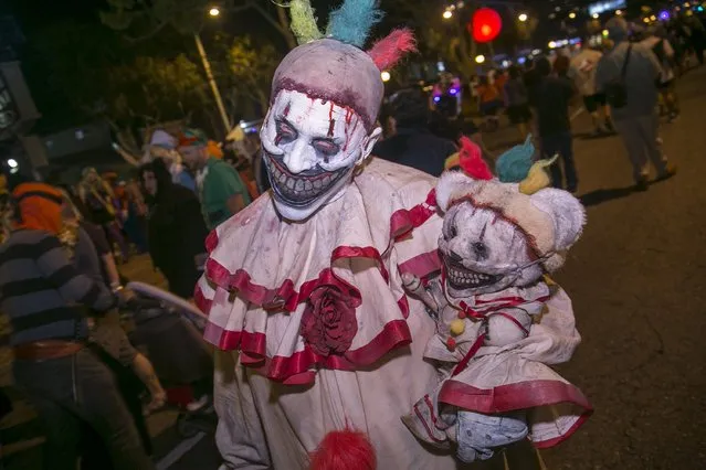 A man dressed as Twisty from the American Horror Story television show poses at the West Hollywood Halloween Costume Carnaval, which attracts nearly 500,000 people annually, in West Hollywood, California October 31, 2015. (Photo by Jonathan Alcorn/Reuters)