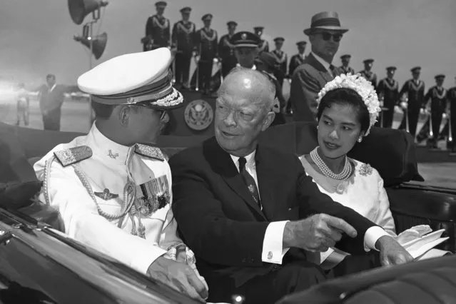 In this June 28, 1960, file photo, U.S. President Dwight Eisenhower, center, is seated between Thailand's King Bhumibol Adulyadej, left, and Queen Sirikit for a motorcade drive from National Airport to the White House in Washington.  (Photo by AP Photo)