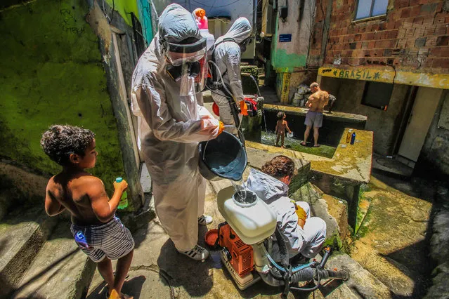 Residents of the Santa Marta favela, Botafogo, south zone in Rio de Janeiro, Brazil unite to sanitize the community and fight the advance of the new coronavirus this Saturday,  November 28, 2020. (Photo by Ellan Lustosa/ZUMA Wire/Rex Features/Shutterstock)