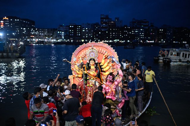 Devotees carry an idol of the Hindu goddess Durga in a boat for immersion in the Buriganga River marking the end of Durga Puja in Dhaka, Bangladesh, Thursday, October 2, 2025. (Photo by Mahmud Hossain Opu/AP Photo(