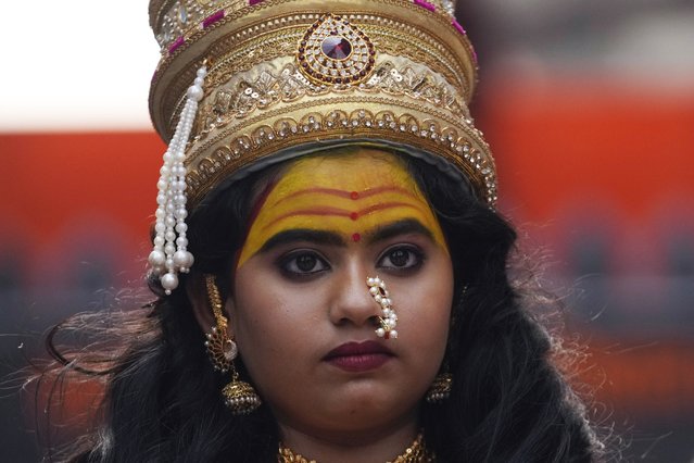 A girl dressed as goddess Laxmi participates in a procession to mark Gudi Padwa or the Marathi New Year in Mumbai, India, Sunday, March 30, 2025. (Photo by Rajanish Kakade/AP Photo)