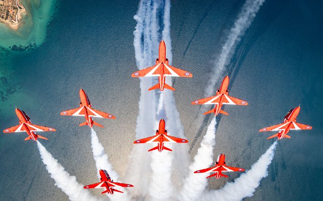 Hawk T1 aircraft of the Royal Air Force Aerobatic Team, the Red Arrows, perform a vertical loop during a practice display in Fitties, Greece on November 10, 2025. The team conducted the display practice as part of Exercise SpringHawk 2025. (Photo by AS1 Iwan Lewis/RAF)