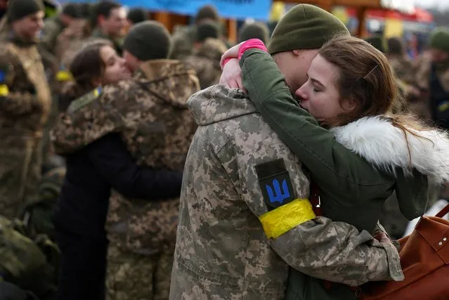 Olga hugs her boyfriend Vlodomyr as they say good bye prior to Vlodomyr’s deployment closer to the front line, amid Russia's invasion of Ukraine, at the train station in Lviv, Ukraine, March 9, 2022. (Photo by Kai Pfaffenbach/Reuters)
