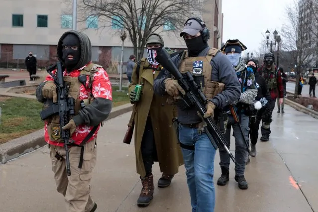 Members of the Boogaloo Bois protest against the election of President-elect Joe Biden, outside the Michigan State Capitol in Lansing, Michigan, U.S. January 17, 2021. (Photo by Rebecca Cook/Reuters)