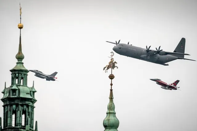 A Hercules C-130 (top) and a F-16 fighter jet of the Royal Danish Air Force fly past Kronborg Castle in Helsingor, Denmark on October 1, 2020. On the occasion of the 70th anniversary of its foundation, the Royal Danish Air Force on October 1 holds an exercise with helicopters, transport aircraft and fighter jets flying over most of the country. (Photo by Mads Claus Rasmussen/Ritzau Scanpix/AFP Photo)